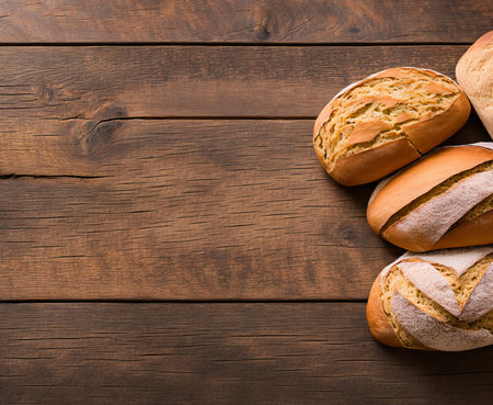 Bread on wooden table. Top view with copy space. Bakery backgroundの写真素材