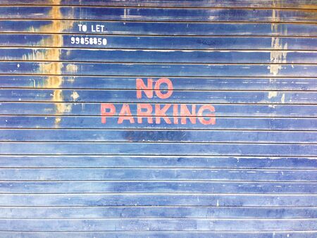 Garage door and no parking sign. No parking in front of garageの写真素材