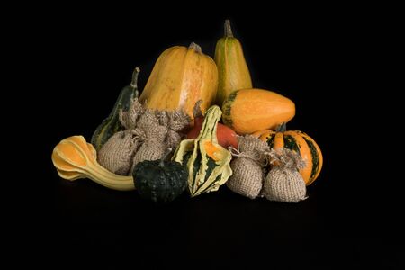 Pumpkins, and a jute bag on a black backgroundの写真素材