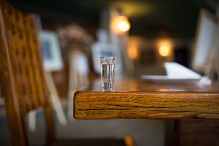 a glass of vodka on the tableの写真素材