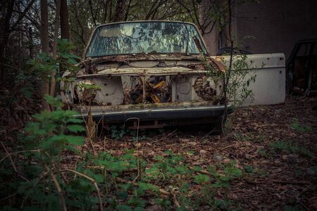 Destroyed and abanoded car in an abandoned place