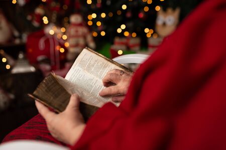 Grandmother reads the Holy Bible in Christmas arrangementの写真素材