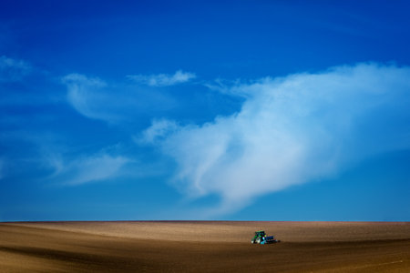 Work with an agricultural tractor in Moravian fields. A wonderful blue sky. Czech Republicの写真素材