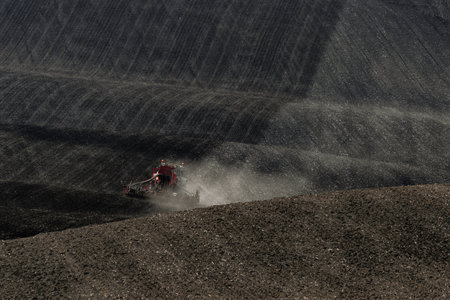 Harsh working conditions for agricultural tractors in Moravian fields in dust. Czech Republicの写真素材