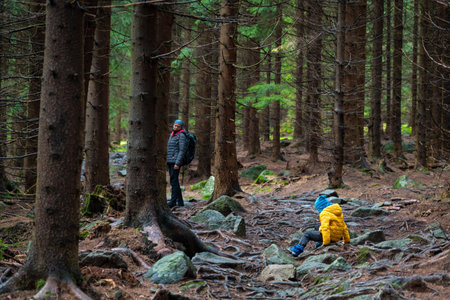 The child slipped and fell on the sloping, wet ground. polish mountains