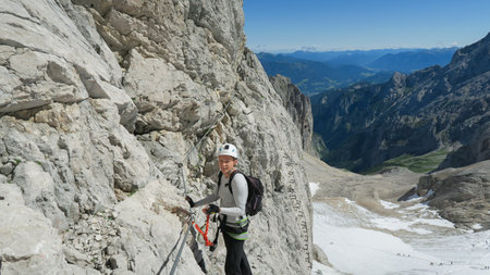 Passage via ferrata with a large exposure and an amazing view of the mountain range and the glacier. Zugspitze massif, Bavarian Alpsの写真素材