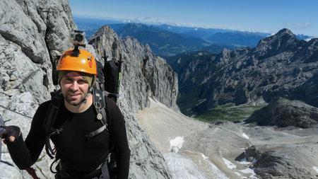 Passage via ferrata with a large exposure and an amazing view of the mountain range and the glacier. Zugspitze massif, Bavarian Alpsの写真素材