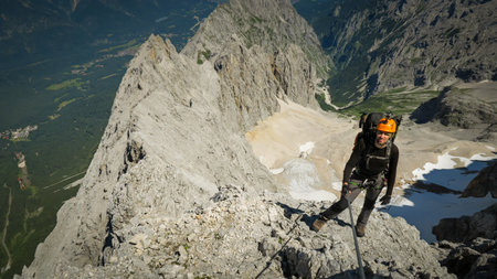 Tourist with equipment on the via ferrata trail in the alps. Zugspitze massif, Bavarian Alpsの写真素材
