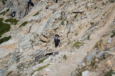 Tourist crossing the via ferrata trail with equipment in the dolomites. Dolomites, Italyの写真素材
