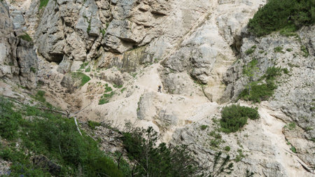 Going through a difficult trail in the full inventory located in the gorge. Dolomites in the Alps.の写真素材
