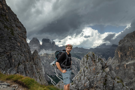 The man in a hat with his back on the background of the panorama in the Dolomites. Dolomites, Italyの写真素材