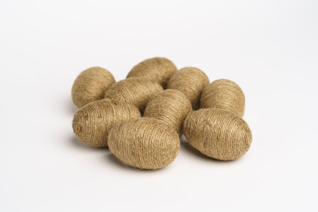 Hand wrapped easter eggs with jute twine, isolated white background. Studioの写真素材