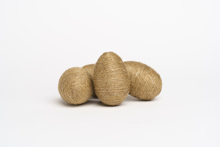 Hand wrapped easter eggs with jute twine, isolated white background. Studioの写真素材