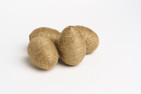 Hand wrapped easter eggs with jute twine, isolated white background. Studioの写真素材