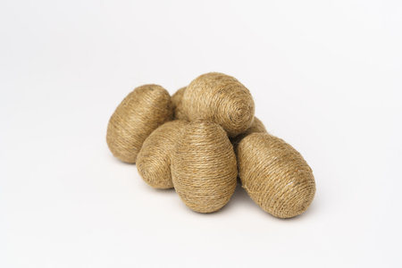 Hand wrapped easter eggs with jute twine, isolated white background. Studioの写真素材