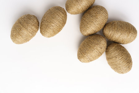 Hand wrapped easter eggs with jute twine, isolated white background. Studioの写真素材