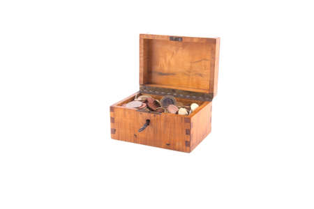Antique handcrafted wooden money box with small money isolated on a white backgroundの写真素材