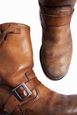 two cognac brown worn fashion boots, one seen from up front, the other from the right side. nice leatherの写真素材