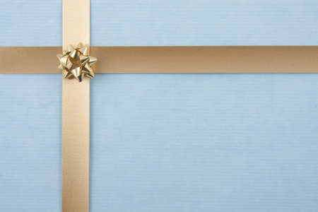 Christmas back ground with gold ribbon on light blueの写真素材