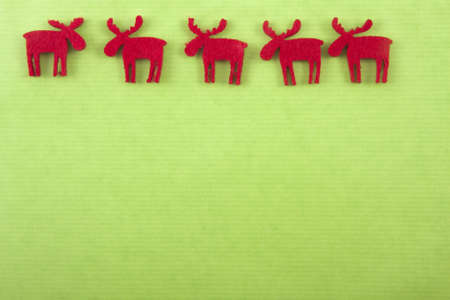 vife felt christmas reindeers on top of a green paperの写真素材