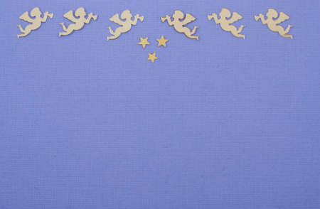 Golden christmas angels on deep purple colored paper の写真素材