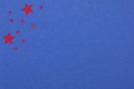 a diversity of red colored stars on deep blue colored paperの写真素材
