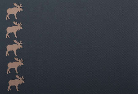 Brown colored reindeer on a structured black paper backgroundの写真素材