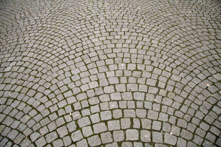 Old grey pavement in a pattern in an old medieval european town.の写真素材