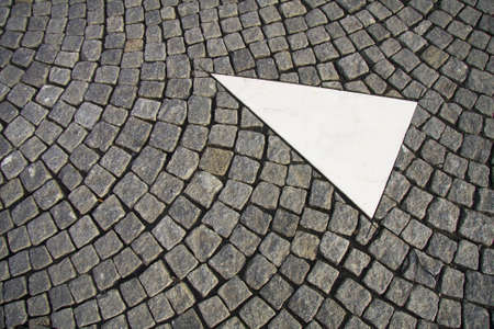 Old grey pavement in a pattern in an old medieval european town. A traffic sign is integrated into the pavement. Possibility for copy spaceの写真素材