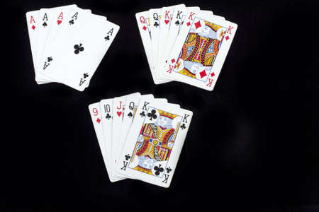 three different winning combinations at a poker game, four of a kind, full house and a street, isolated on whiteのeditorial素材