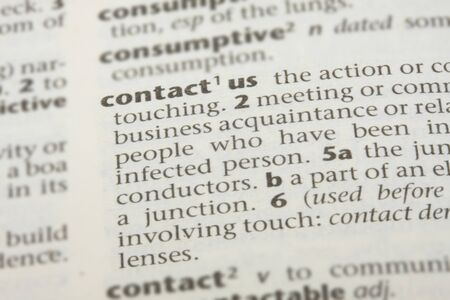 Close up of the dictionary definition for contact usの写真素材