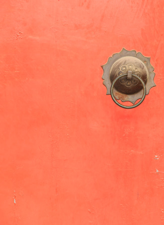 Couple of Antique Brass Ring Pull Handles on Red Doorの写真素材