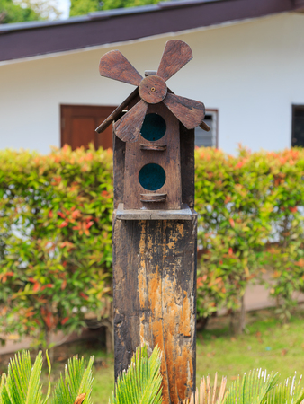 Closeup of bird wood house and windmill decorated in the gardenの写真素材
