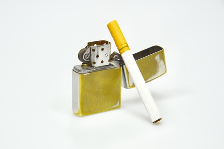lighter and cigarette over the white backgroundの写真素材