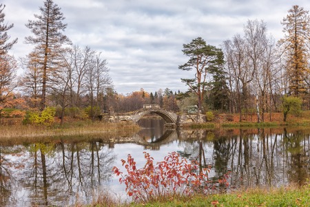 Autumn landscape with the lake and the old bridgeの写真素材