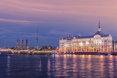 SAINT PETERSBURG, RUSSIA ? MAY 23, 2017: Russian cruiser Aurora - Russian protected cruiser (now it is museum ship) and Nakhimov Naval School at nightのeditorial素材