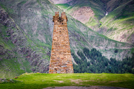 An old watchtower on the background of the mountains near the Georgian Military Road, Georgiaの写真素材