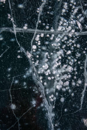 Blue background of Ice texture. Ice and cracks of Lake Baikal in Winterの写真素材