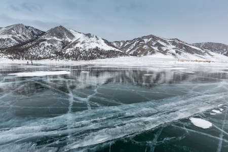 Frozen Lake Baikal. Blue ice with cracks near Olkhon Island, winter landscape.の写真素材