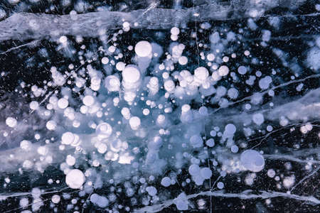 Blue background of Ice texture. Ice and cracks of Lake Baikal in Winterの写真素材