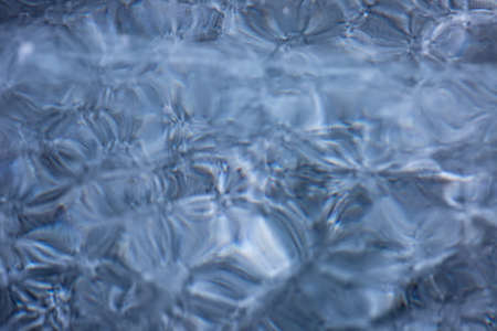 Blue background of Ice texture. Ice and cracks of Lake Baikal in Winterの写真素材