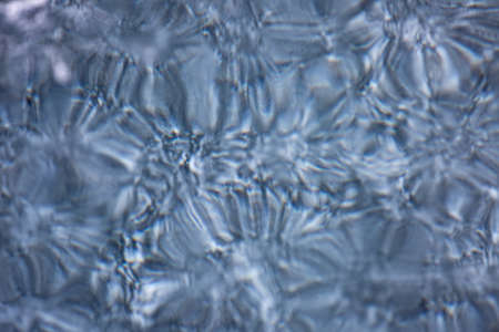 Blue background of Ice texture. Ice and cracks of Lake Baikal in Winterの写真素材