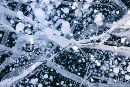 Blue background of Ice texture. Ice and cracks of Lake Baikal in Winterの写真素材