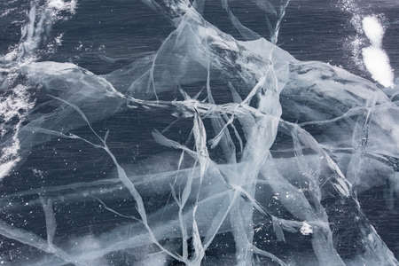 Blue background of Ice texture. Ice and cracks of Lake Baikal in Winter