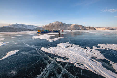 Frozen Lake Baikal. Blue ice with cracks near Olkhon Island, winter landscape.の写真素材