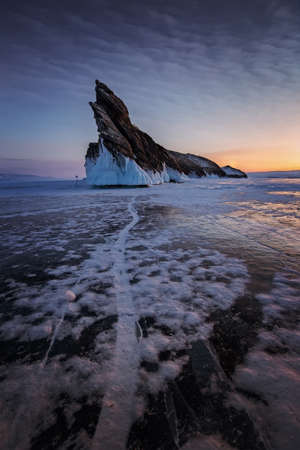 Dawn on the winter frozen Lake Baikal, ice, island in the backgroundの写真素材
