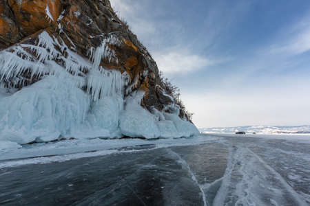 Frozen Lake Baikal. Blue ice with cracks near Olkhon Island, winter landscape.の写真素材