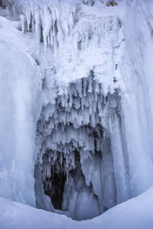 Ice cave, Icicles in the rocky caves, Lake Baikal in winter, Siberia, Russia