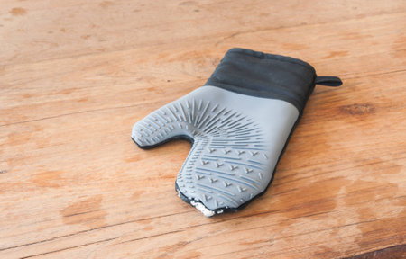 Cooking glove on wood tableの写真素材