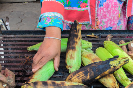 Grilled corn and yam or sweet potato on charcoal stove, selective focus